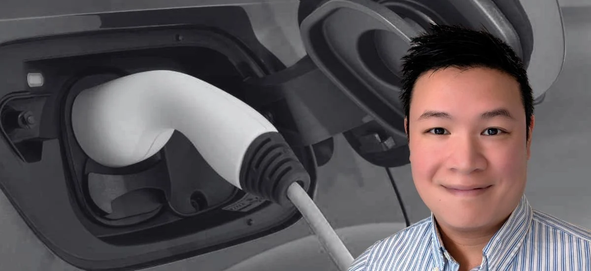 Willy Thao, responsable France de Frank Énergie, sur fond de prise de recharge d'une voiture électrique
